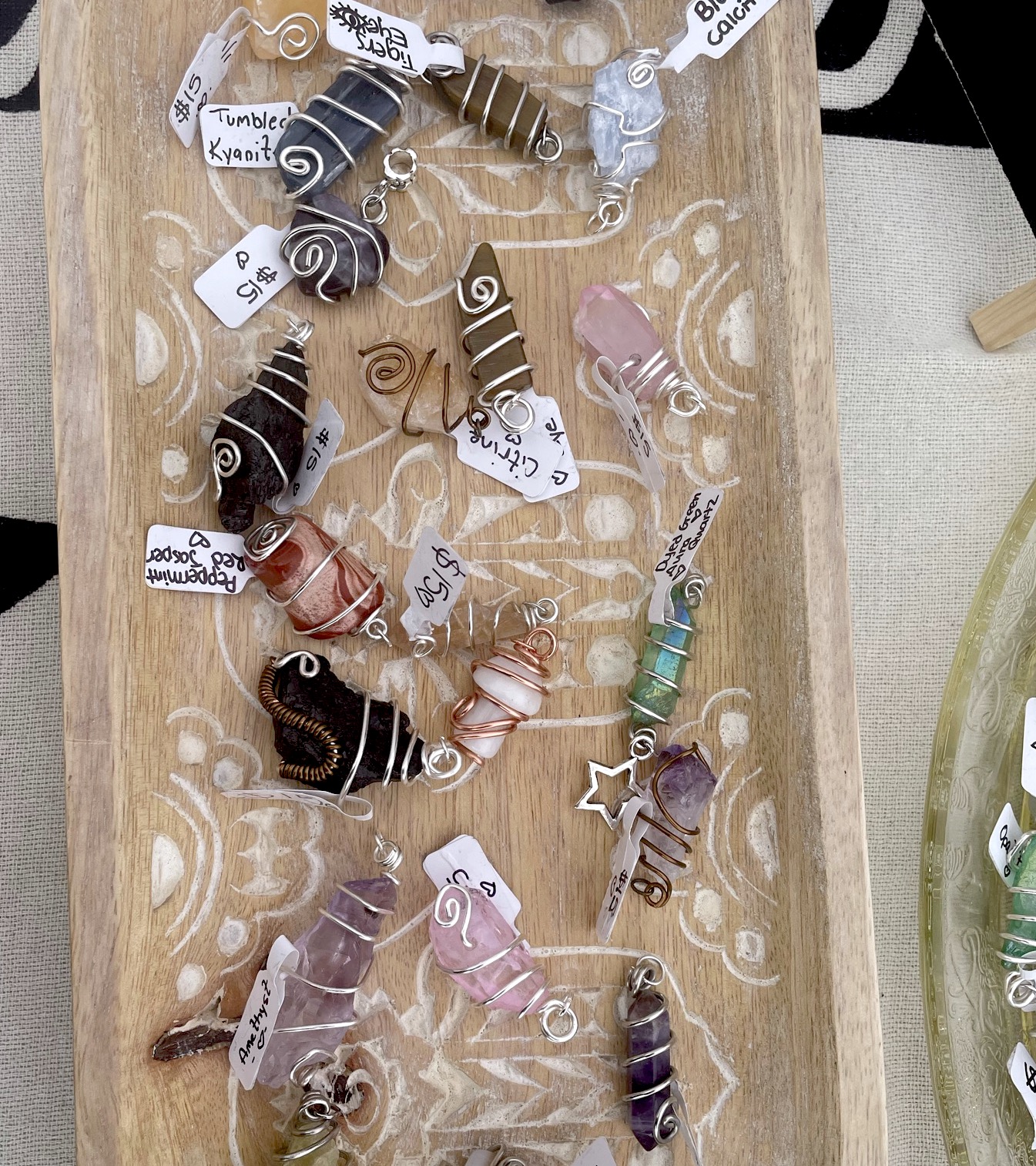 Bowl of natural gemstones, wire-wrapped, and priced. Made by Sophie's Crystals.