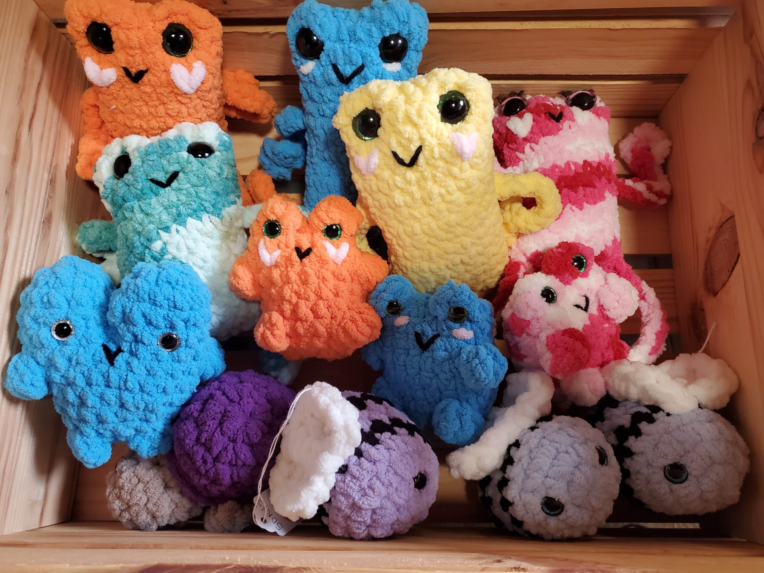 Yellow, Blue, Pink, Purple, Orange, Teal squishy crocheted stuffed animals. Handmade by "Sonirations"