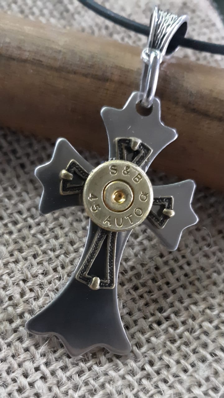 Cross pendant with spent ammo in center of cross.