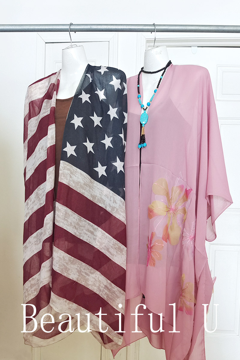 American flag and bright pink dresses, hanging on coat hangers. Made in Michigan.